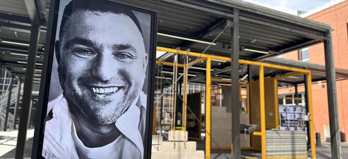Menschen auf dem Bau Großes männliches Porträt im Eingangsbereich der Ausstellung "Hochbau"