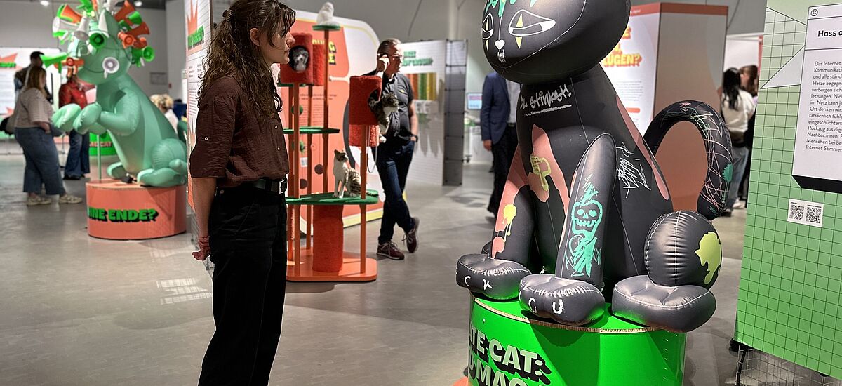 Hate Cat Besucherin tritt einer Katze, die für Hass im Internet steht, gegenüber